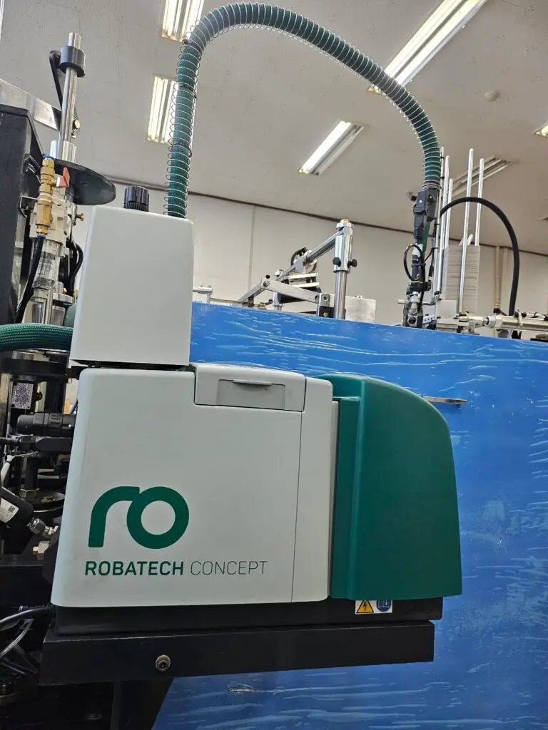 Hot melt adhesive system integrated in paper cup forming machine for stable and strong bonding